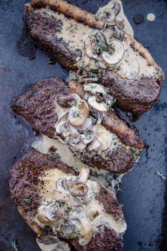 Grilled Picanha steaks topped with a mushroom cream sauce. 