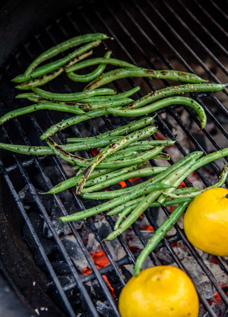 Fresh Green Beans and lemon halves on the grill 