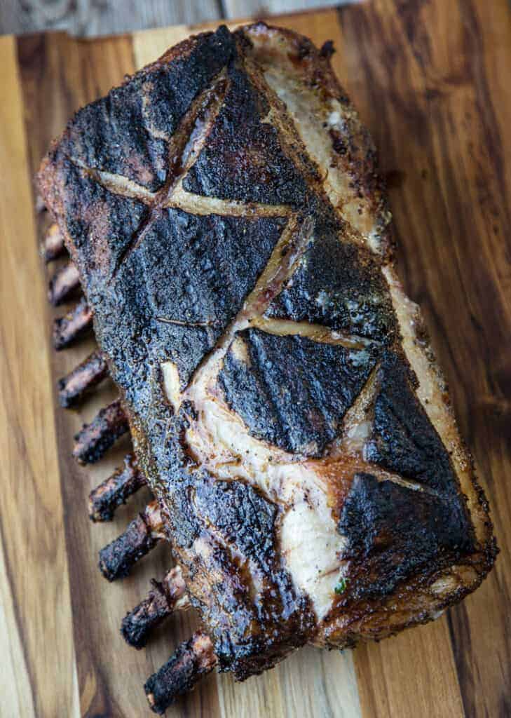 Grilled bone-in pork roast on a cutting board