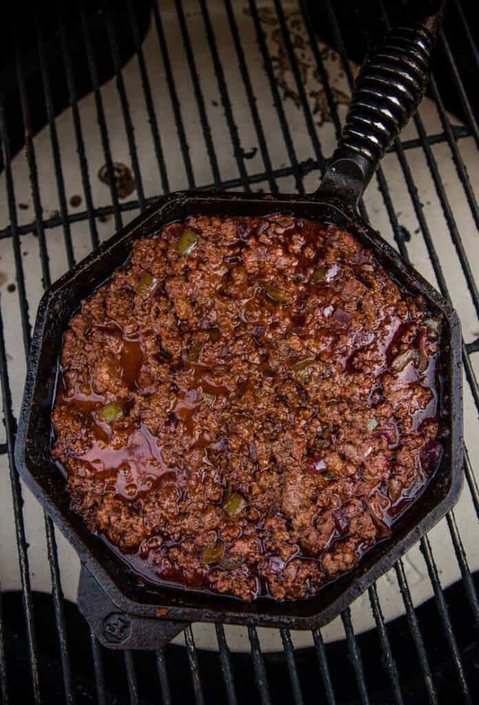 Sloppy Joe filling in a cast iron skillet in a smoker