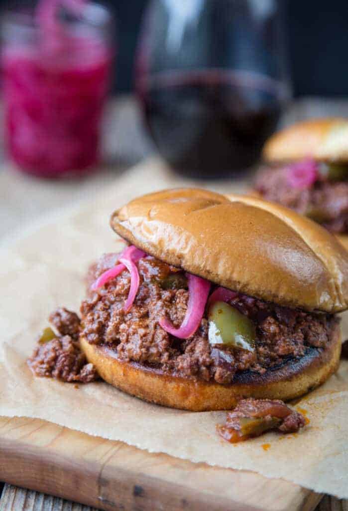 Smoked Sloppy Joe Sandwich on a bun with pickled red onions