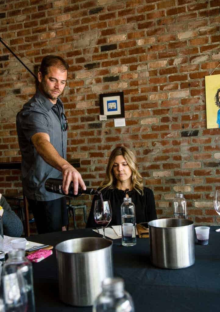 man pouring red wine