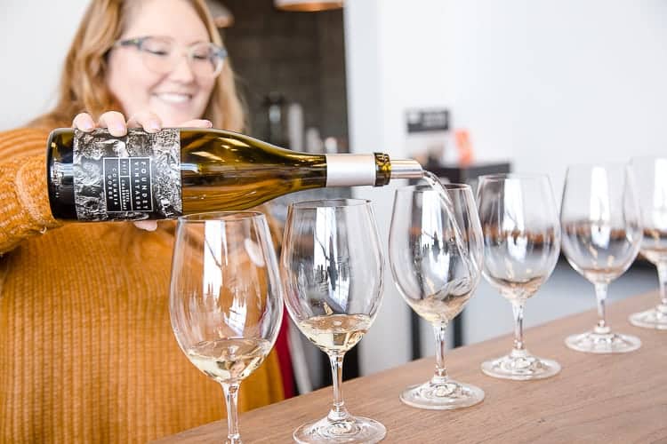 woman pouring white wine