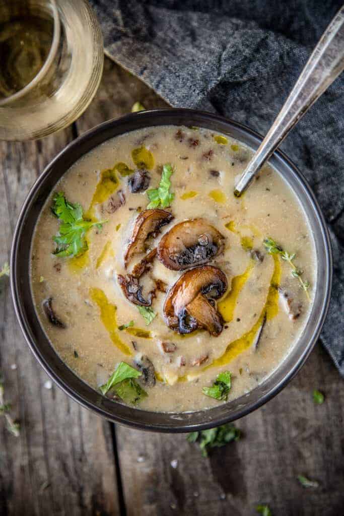 A bowl of Wild Mushroom Soup with a glass of wine
