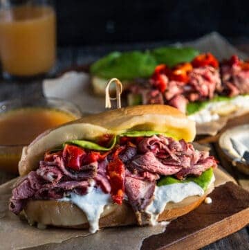 French Dip Sandwiches on a cutting board with homemade au jus sauce