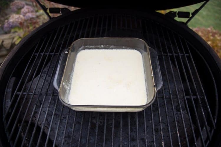 Milk in a glass dish on a smoker