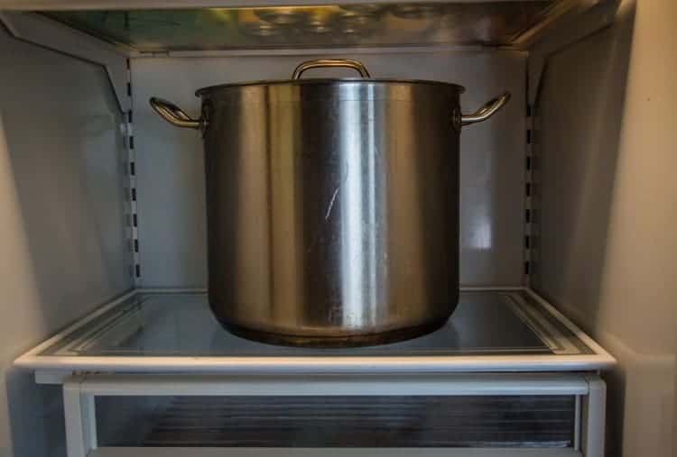 A large stock pot in a refrigerator