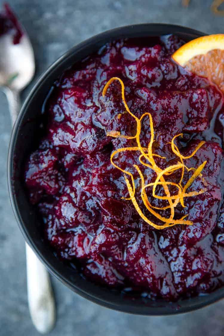 A bowl of Homemade Red Wine Cranberry Sauce with orange zest on top