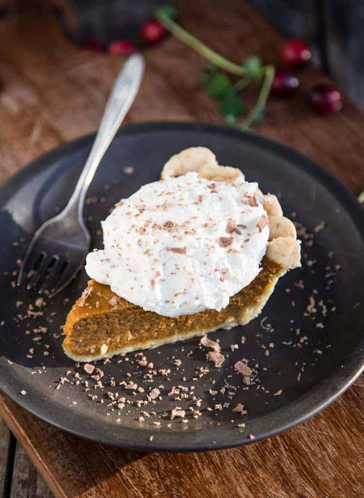 Smoked Whipped Cream on top of a slice of pumpkin pie