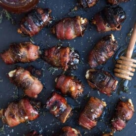 Grilled Bacon Wrapped Stuffed Dates on a platter