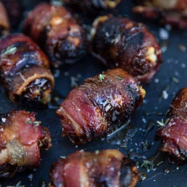 Grilled Bacon Wrapped Stuffed Dates on a platter