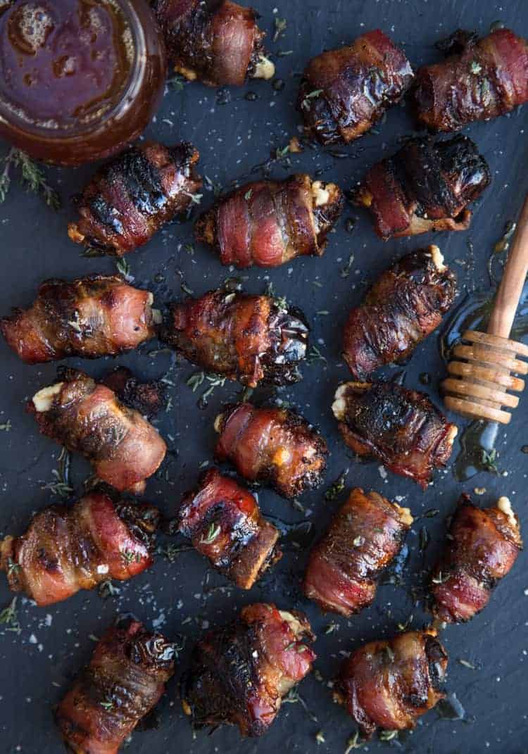 Grilled Bacon Wrapped Stuffed Dates on a platter