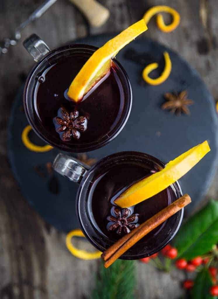Two glasses of Mulled Wine garnished with star anise and cinnamon