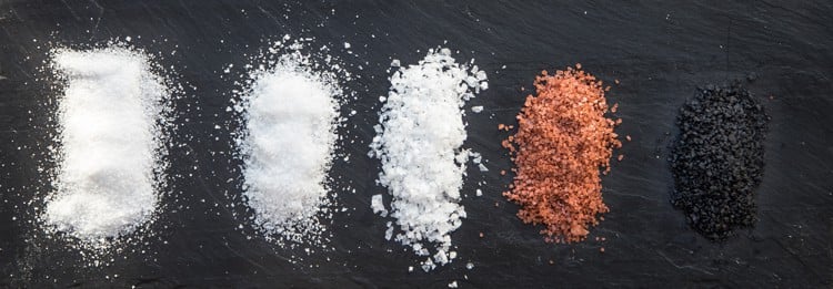 A variety of kosher salts lined up for comparison.