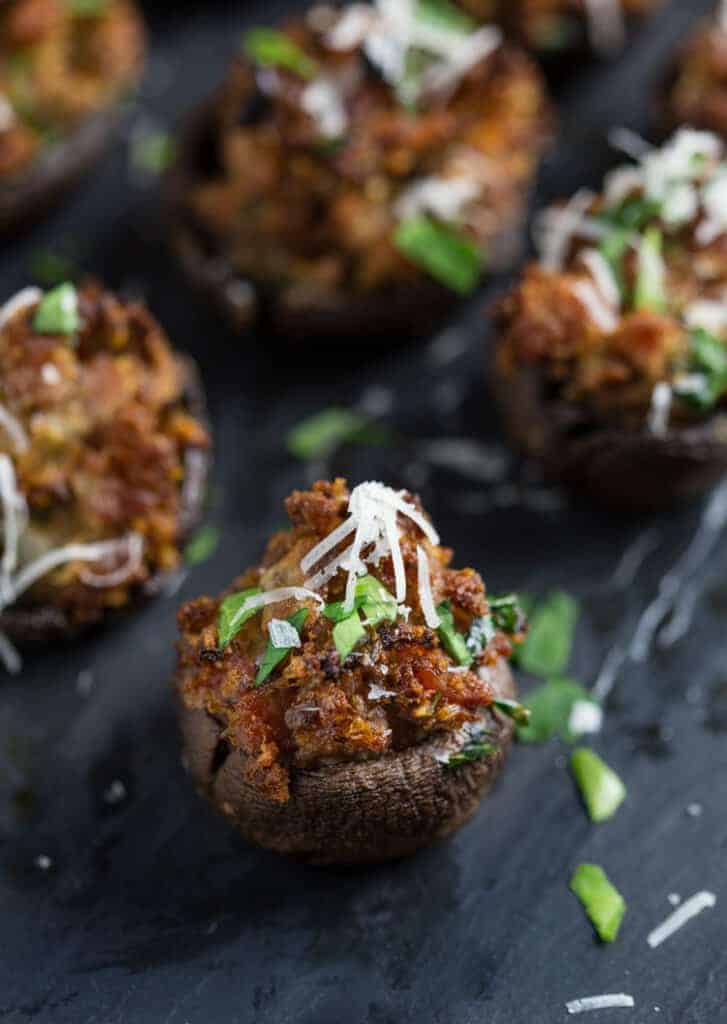 sausage stuffed mushroom recipe topped with parmesan cheese and parsley