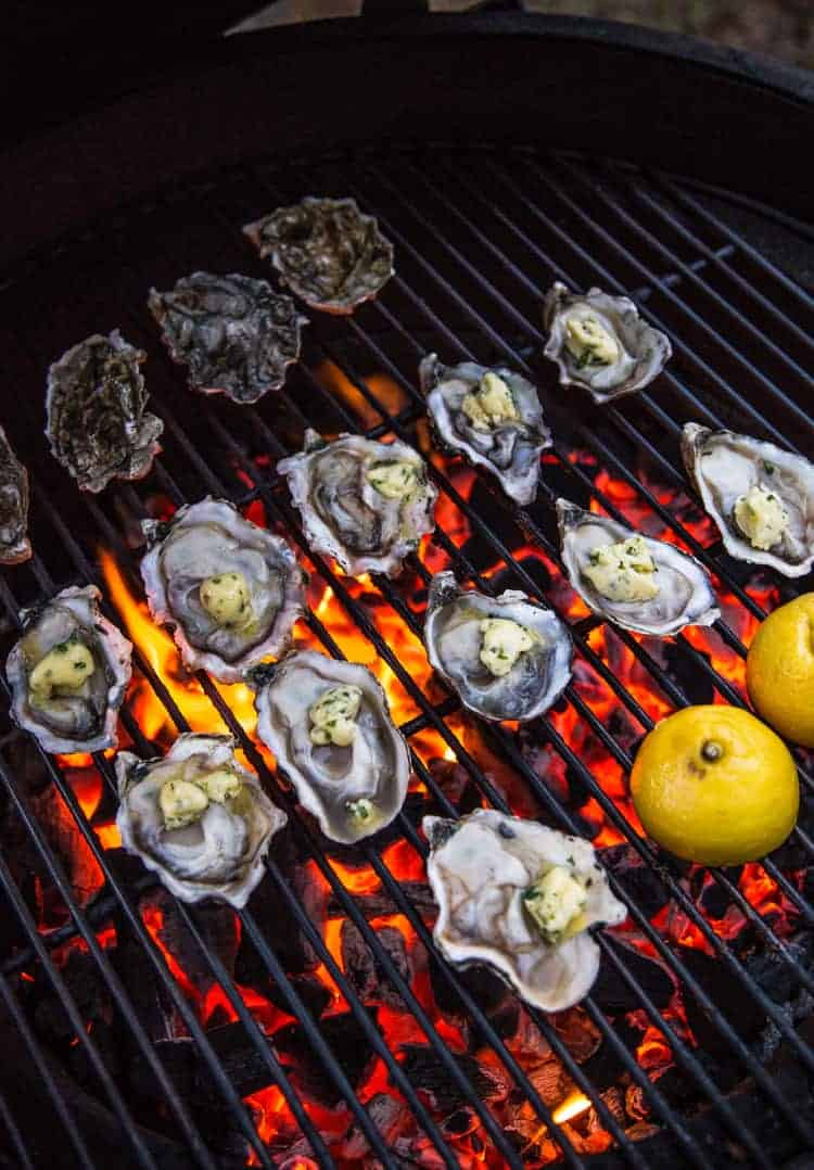 Grilled oysters cooking on a big green egg over direct heat