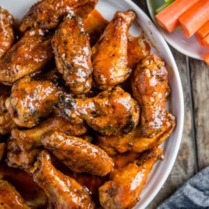 top down image of smoked buffalo wings with ranch, carrots, and celery