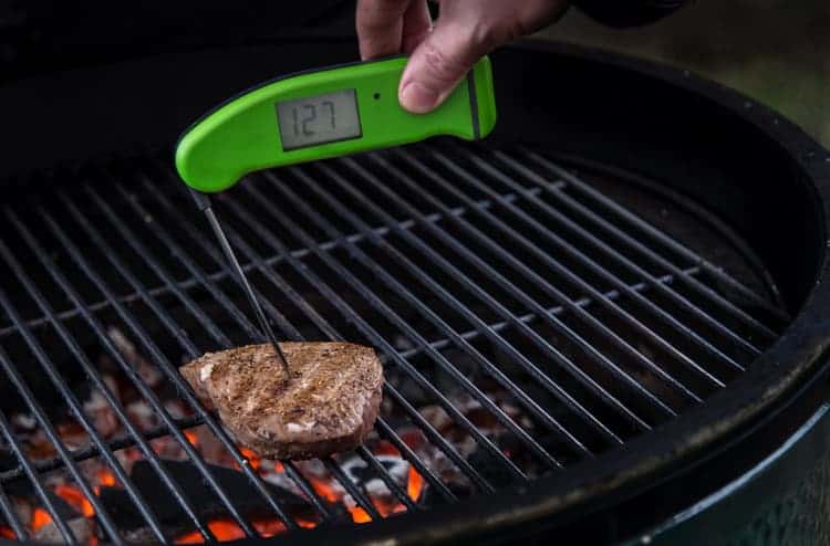 Checking the temperature of ahi tuna steaks with a digital thermometer