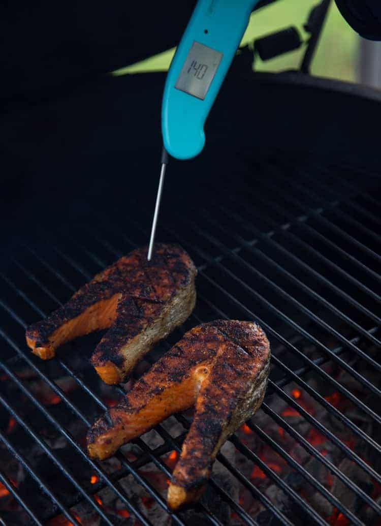 Taking temperature meat with a digital Thermapen thermometer 