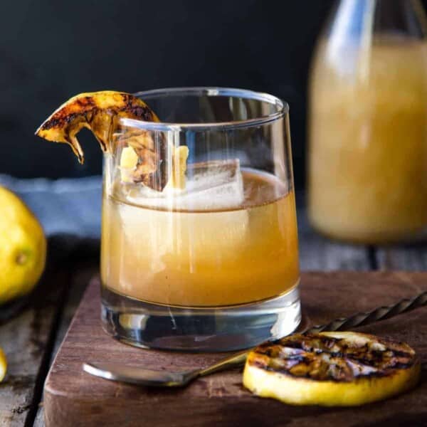Bourbon cocktail made with grilled lemon in a glass.