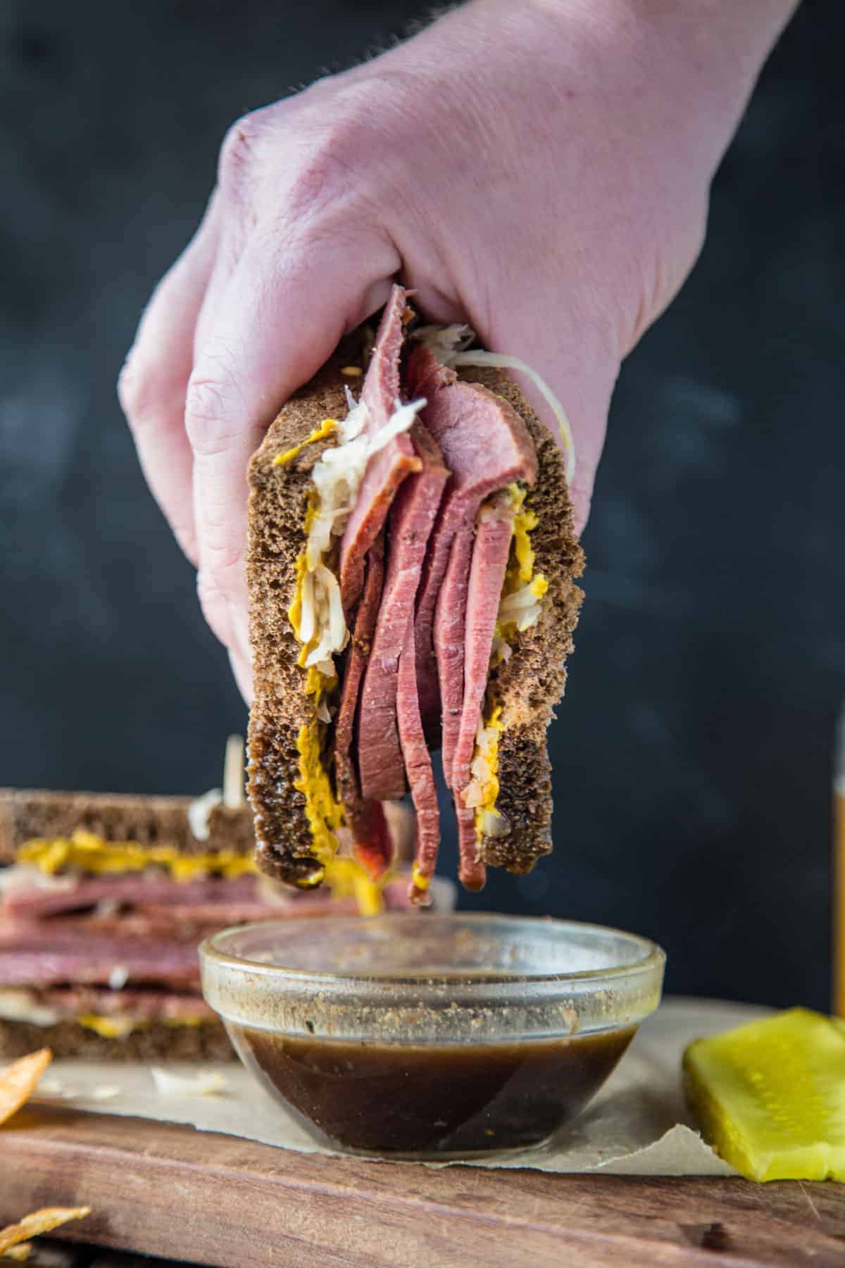 Dipping a Corned Beef Sandwich in Guinness Au Jus dipping sauce