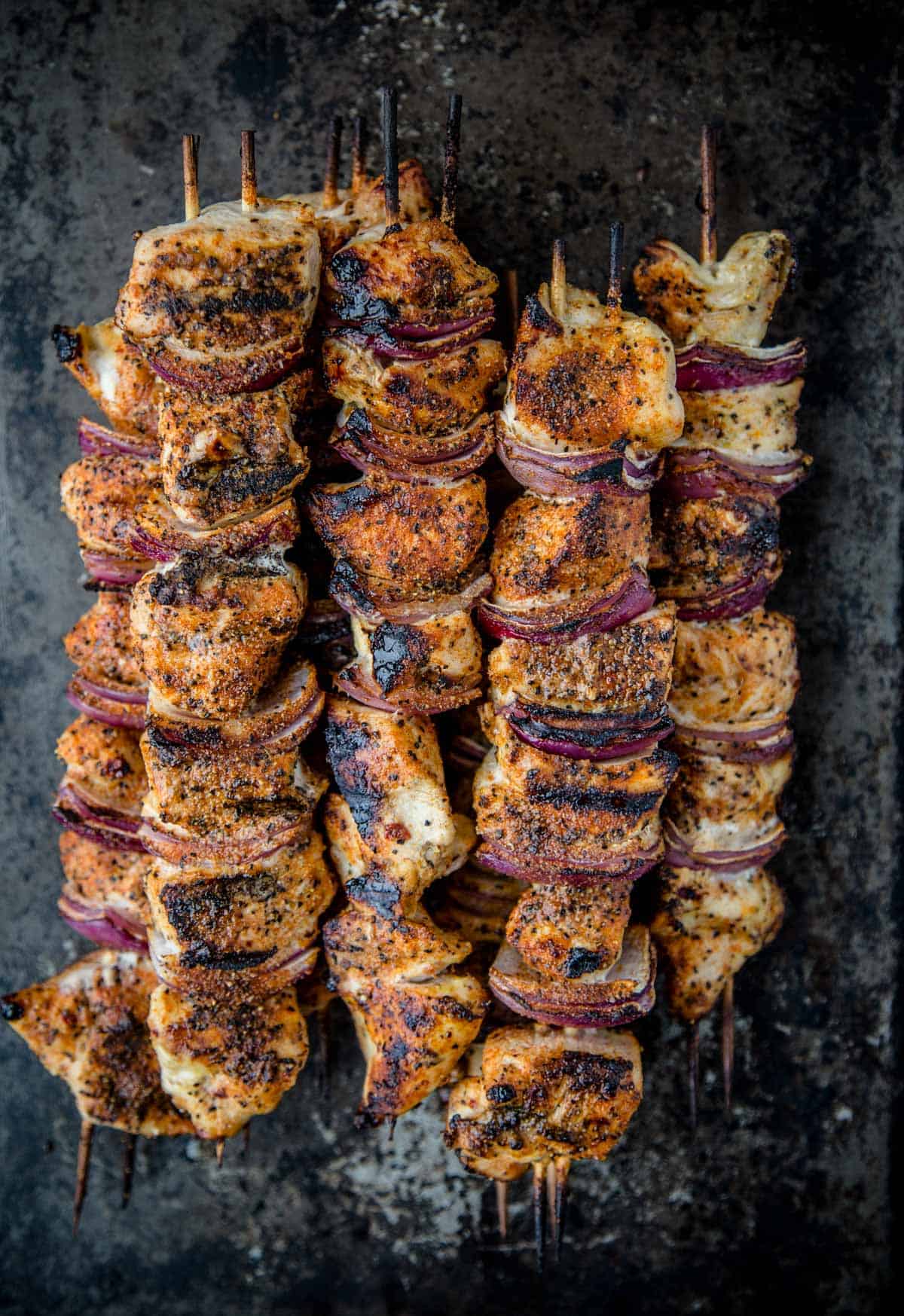 The best marinade for grilled chicken on chicken kebabs resting on a platter.