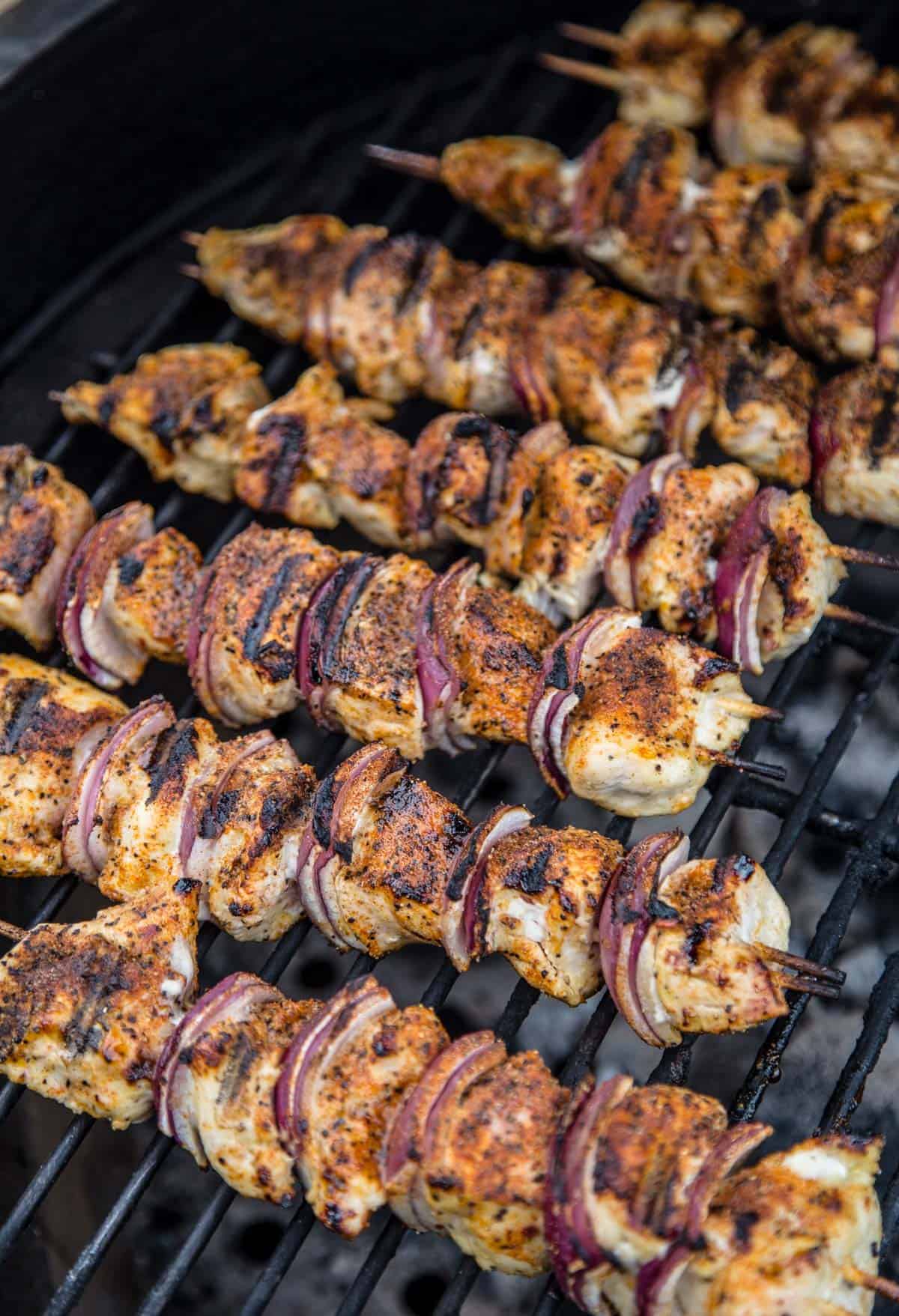 Grilled Chicken Kebabs cooking over indirect heat on a grill.