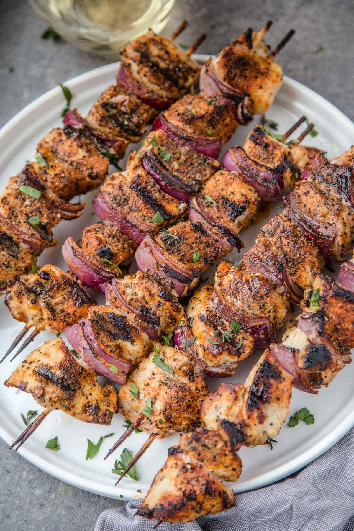 Grilled Chicken Skewers on a white platter.