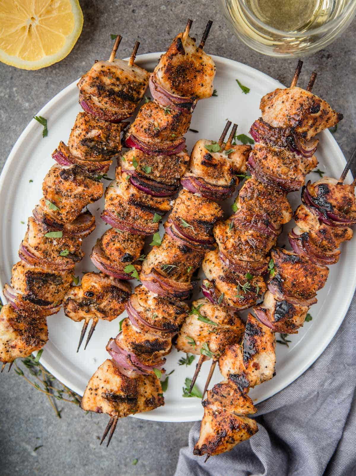 Grilled Marinated Chicken Kebabs on a white plate.