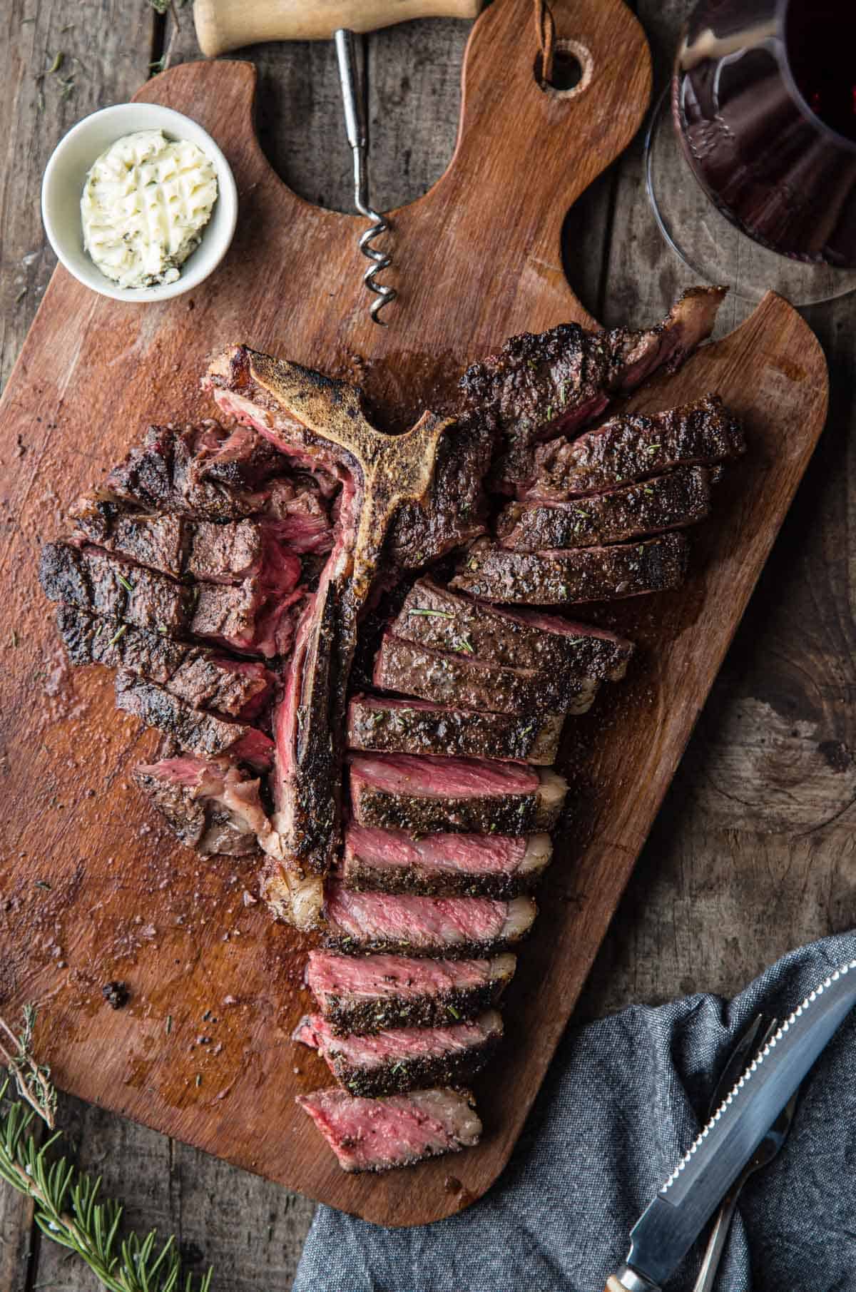 A sliced T Bone Steak on a cutting boar