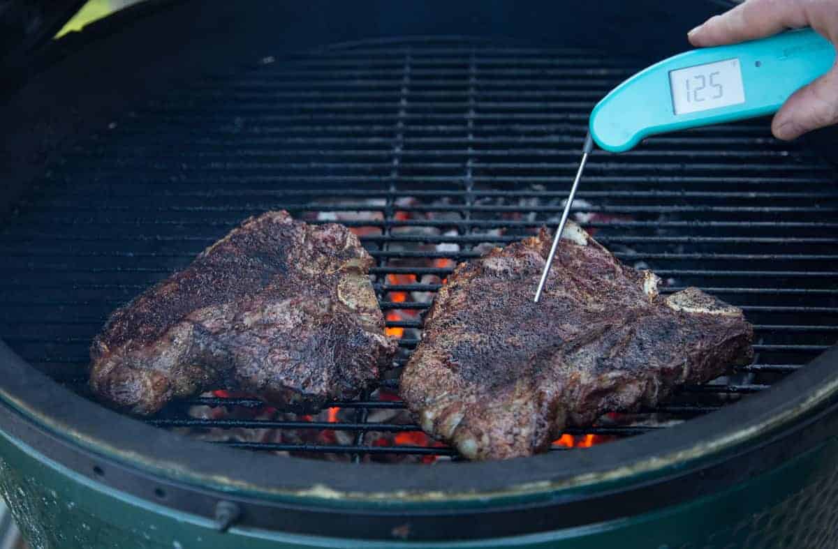 Taking temperature of grilled steaks using a Thermoworks Digital Thermometer