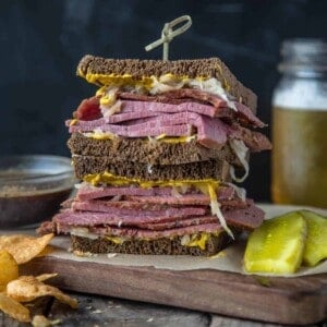 A Loaded Corned Beef Sandwich on a cutting board