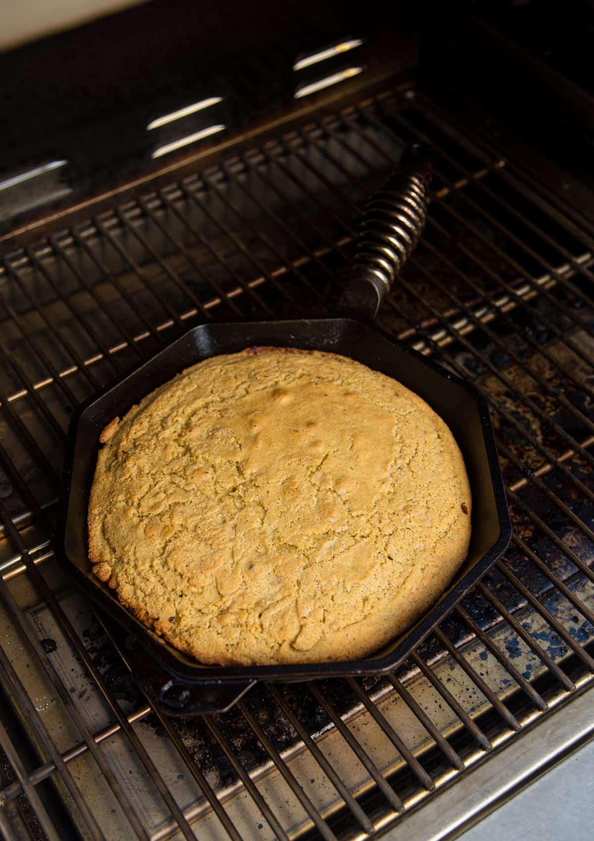 Cornbread cooked in the grill in a cast iron pan