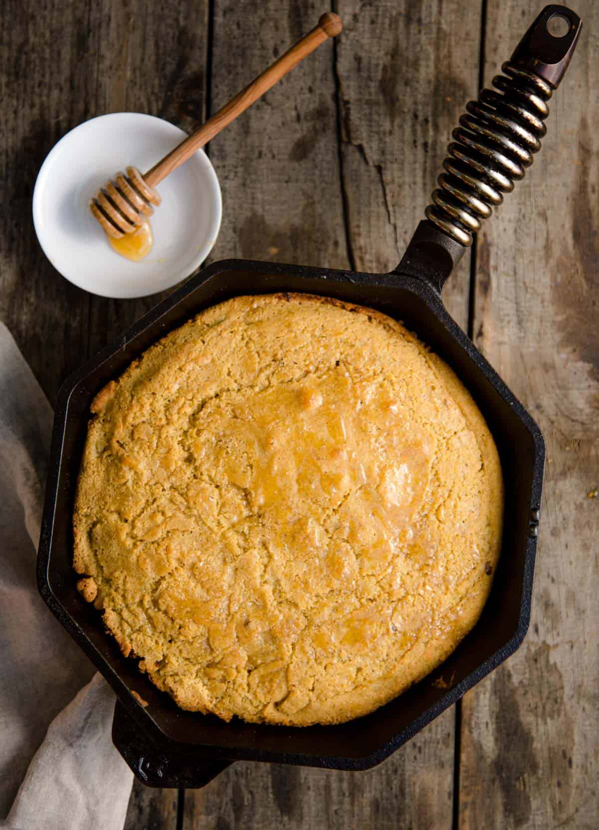 Skillet Cornbread with a drizzle of smoked honey that was cooked on the grill.