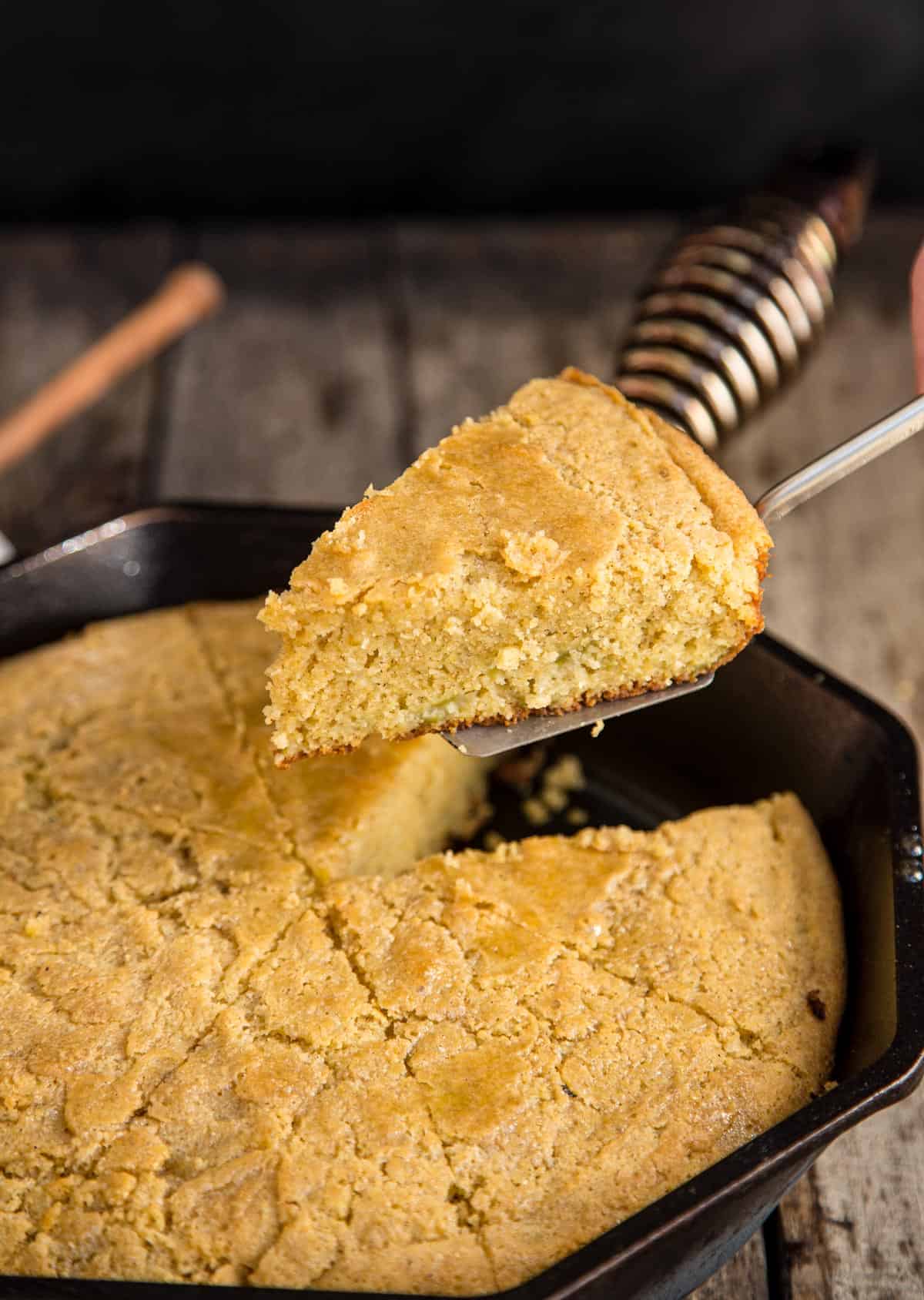 A slice of Cast Iron Skillet Cornbread made with gluten free flour