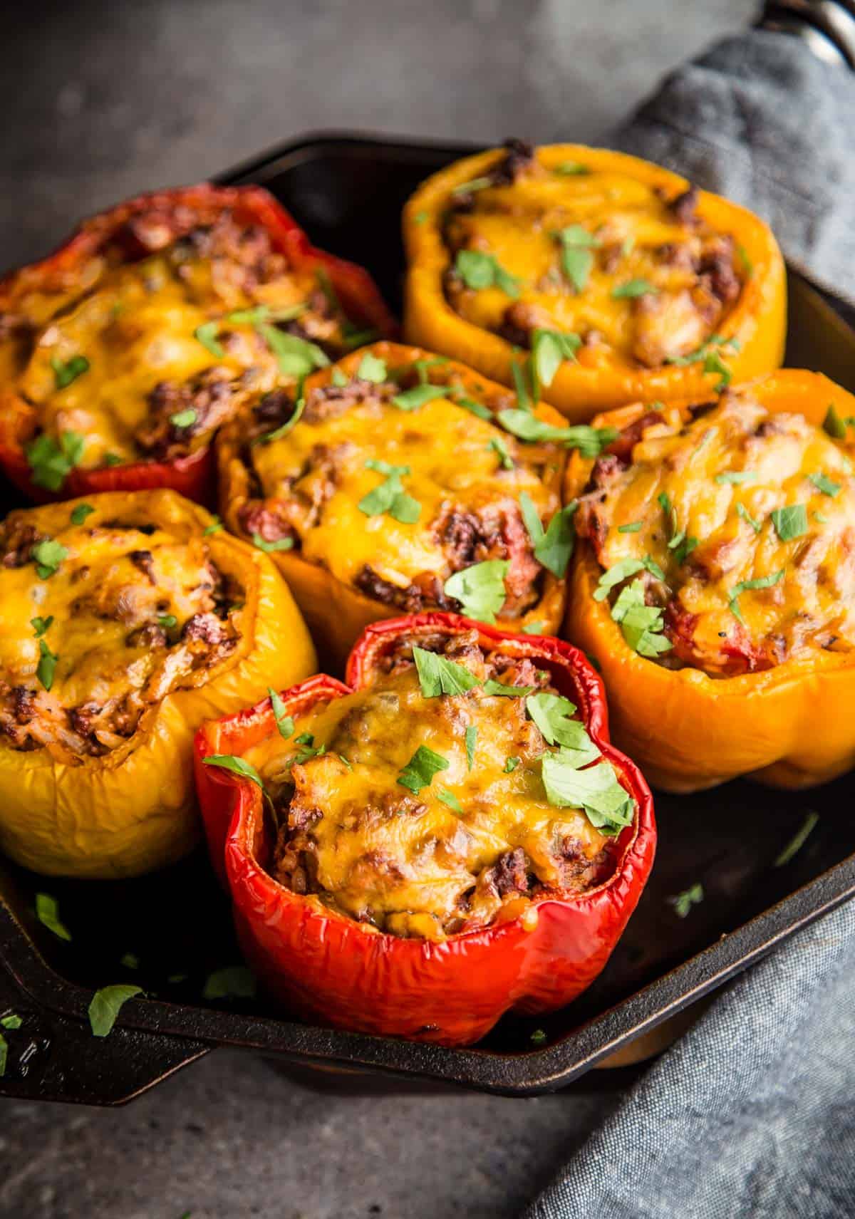 Ground Beef Grilled Stuffed Bell Peppers resting in a cast iron pan