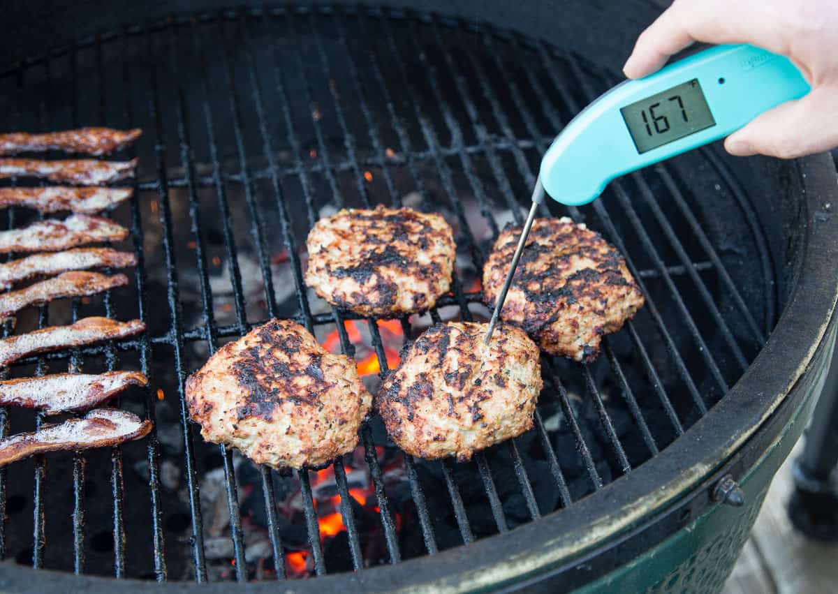Taking the temperature of turkey burgers with a Thermapen digital thermometer