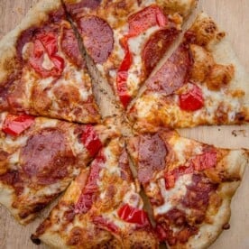 A grilled pepperoni and hot pepper pizza, cut into 6 slices