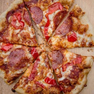 A grilled pepperoni and hot pepper pizza, cut into 6 slices