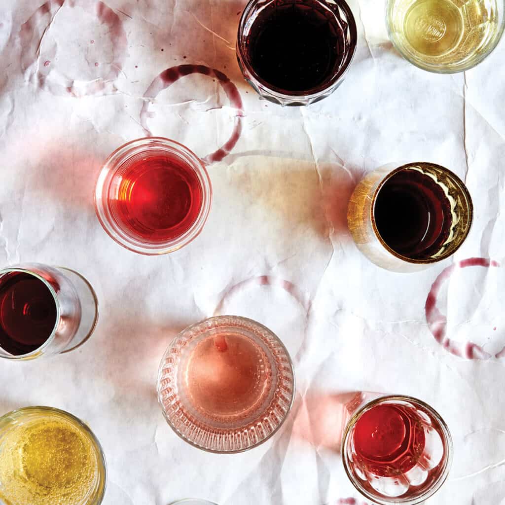 A top down photo of different glasses of wine, taken from Dina Avila for the Fire and Wine cookbook