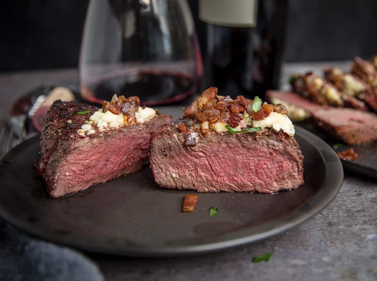 A grilled filet mignon cooked to rare cut in half