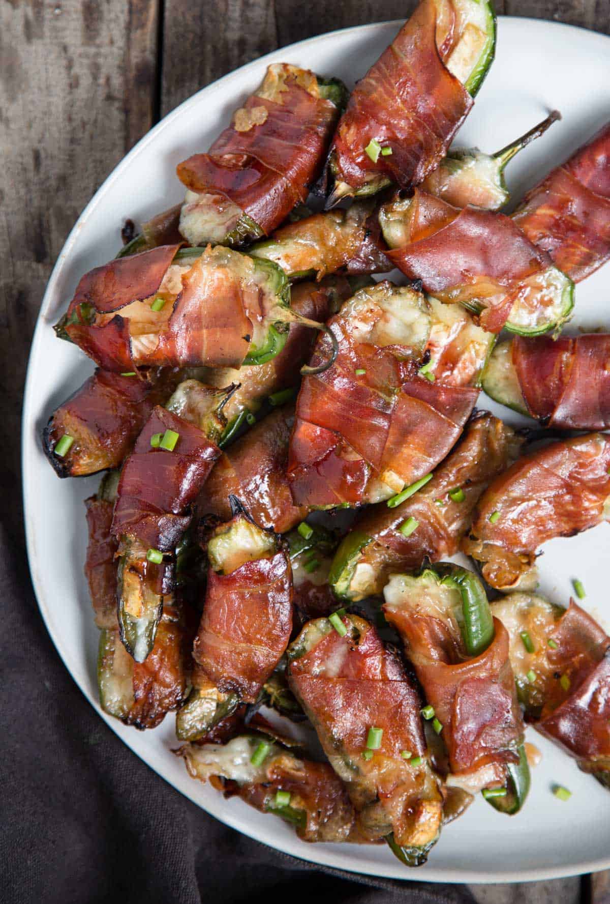 Jalapeño Poppers with Brie and Prosciutto on a serving platter.