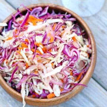 mayo free coleslaw in a brown bowl on a wooden table