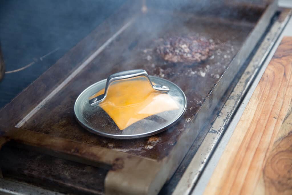 Melting cheese on a smash burger