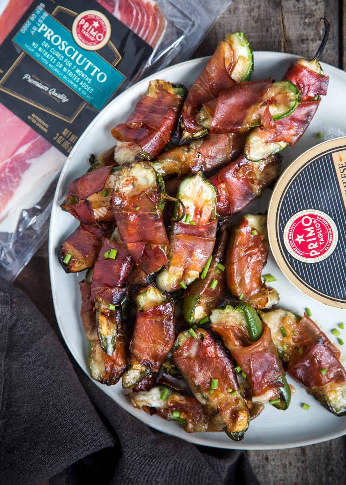 A platter of Jalapeno Poppers stuffed with brie cheese and prosciutto.