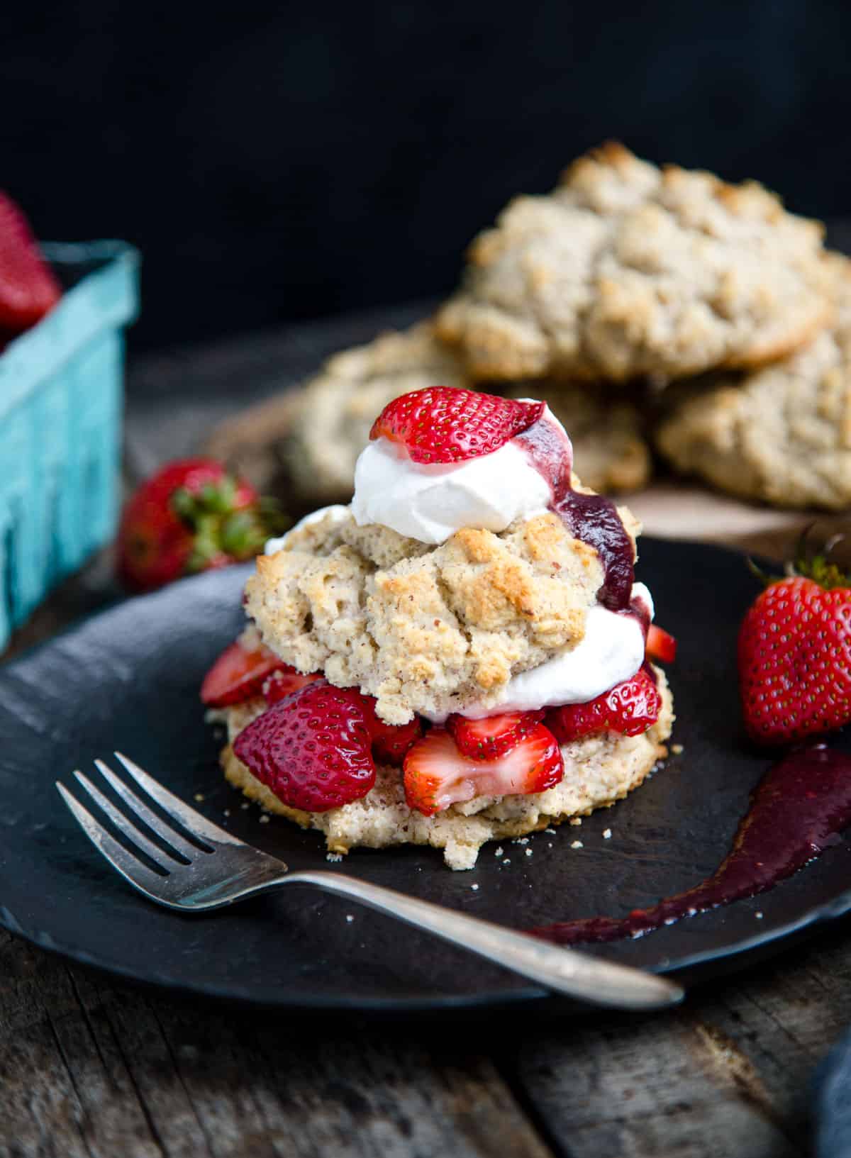 Smoked Strawberry Shortcake on a black plate with a fork