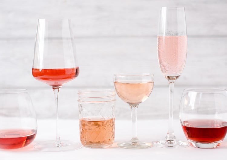 Different glasses with various styles of rose wine