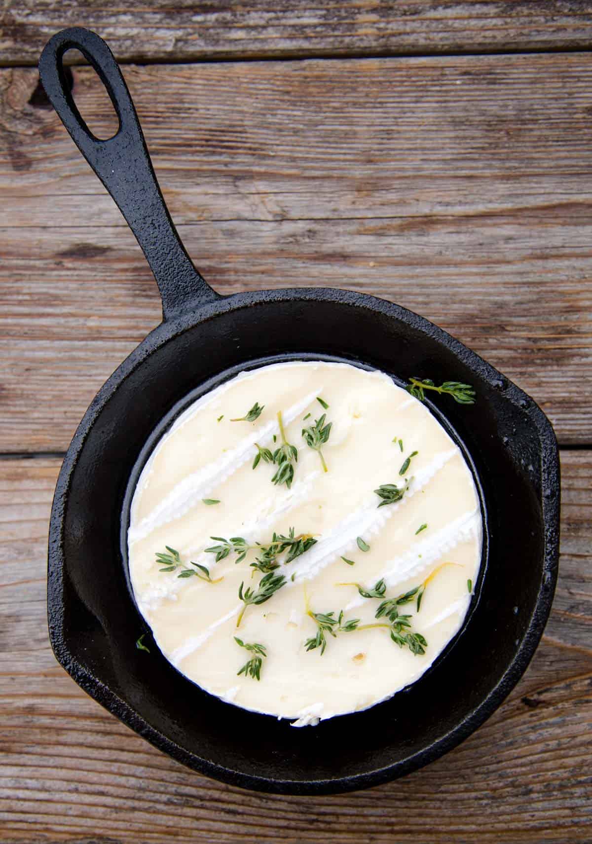 Brie cheese in a cast iron pan