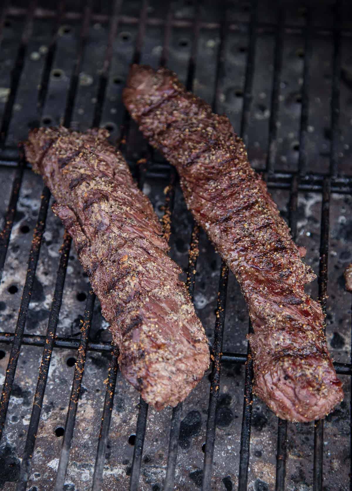 2 Hanger Steaks cooking on a grill