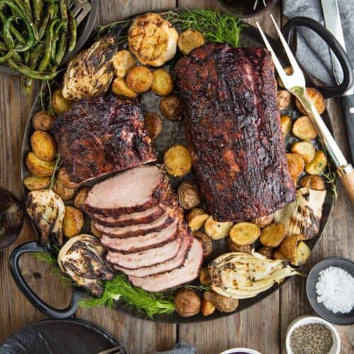 Pork Loin with Blackberry Wine Glaze on a platter with roasted potatoes